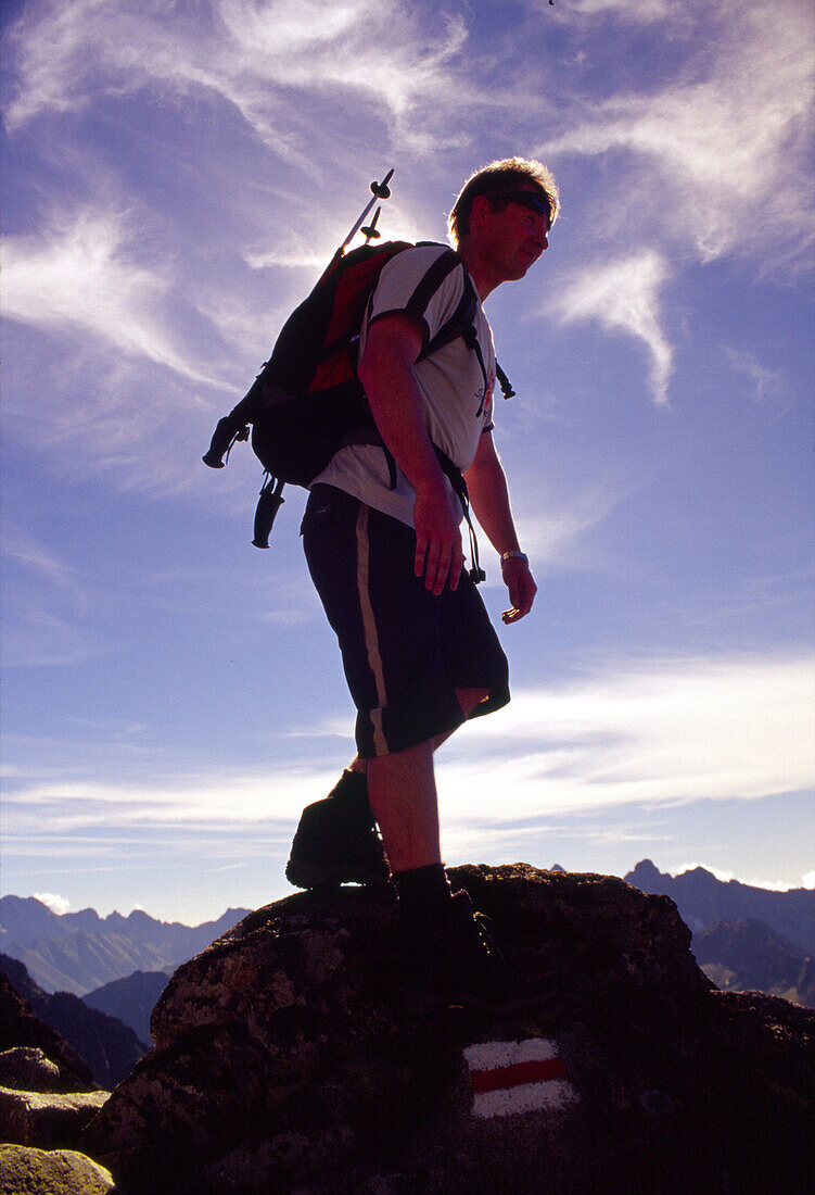 Hiker at the top of Kozi Wierch, Part of The Eagl High Tatras, Poland
