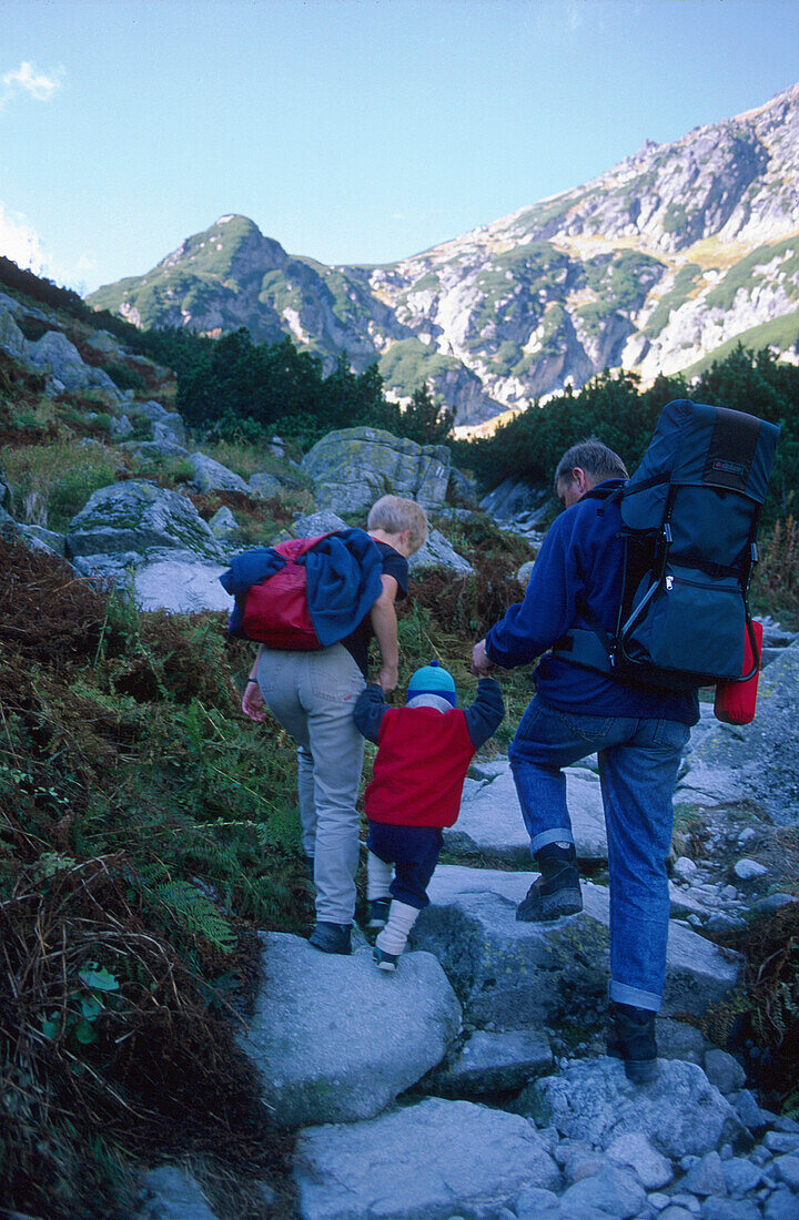 Hikers with child in Roztoka Valley, High Tatras, Poland