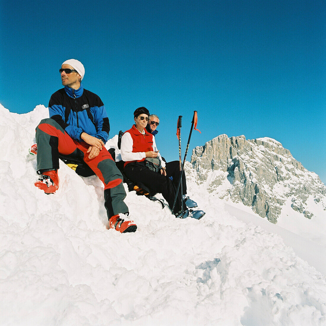 Skitouring, Skitouring, Three people sitting on a mountain peak, St. Antoenien, Graubuenden, Switzerland, St. Antoenien, Graubuenden, Switzerland
