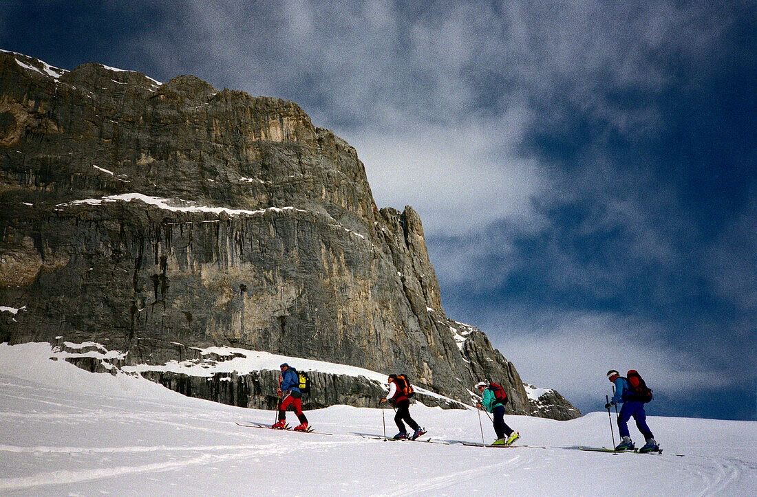 Four people on a skitour, skiing, St. Antoenien, Grisons, Switzerland