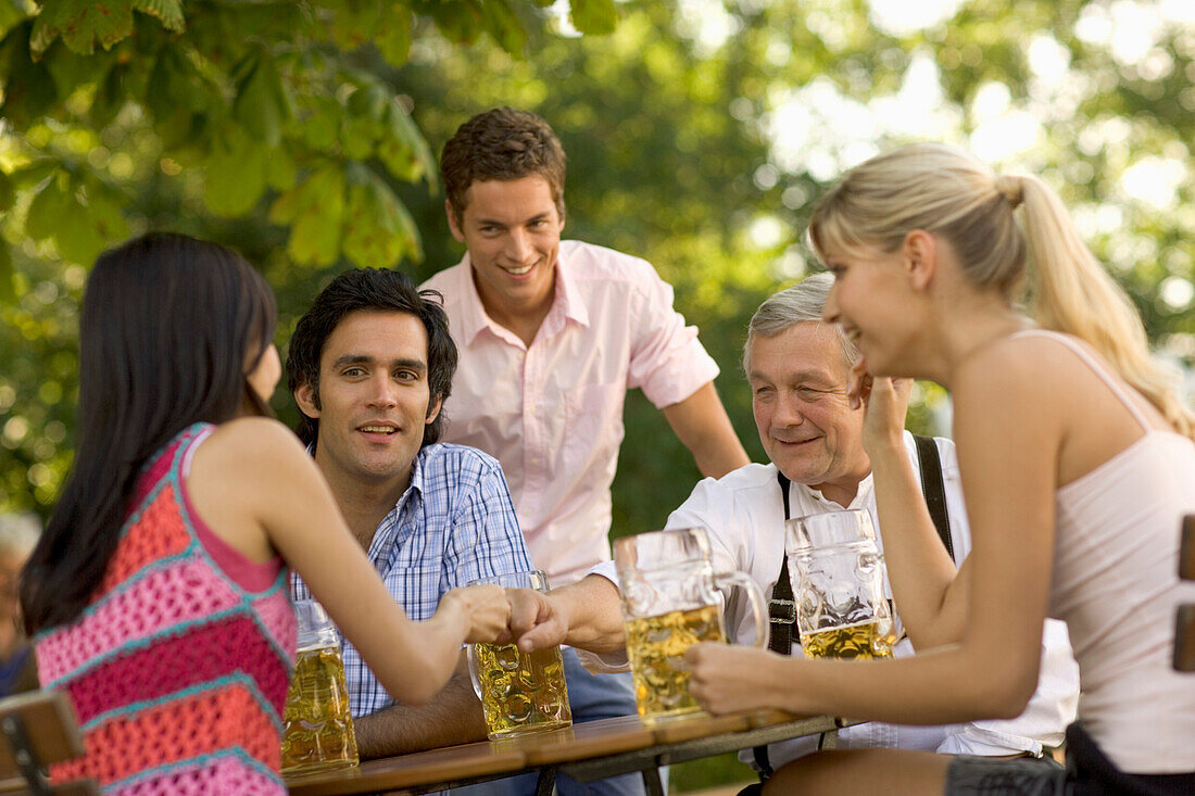 Friends in a beer garden,Fingerhakeln, Lake Starnberg, Bavaria, Germany