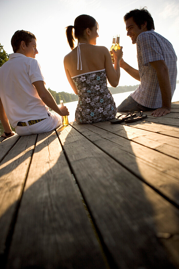 Friends on footbridge, Starnberger See Bavaria, Germany