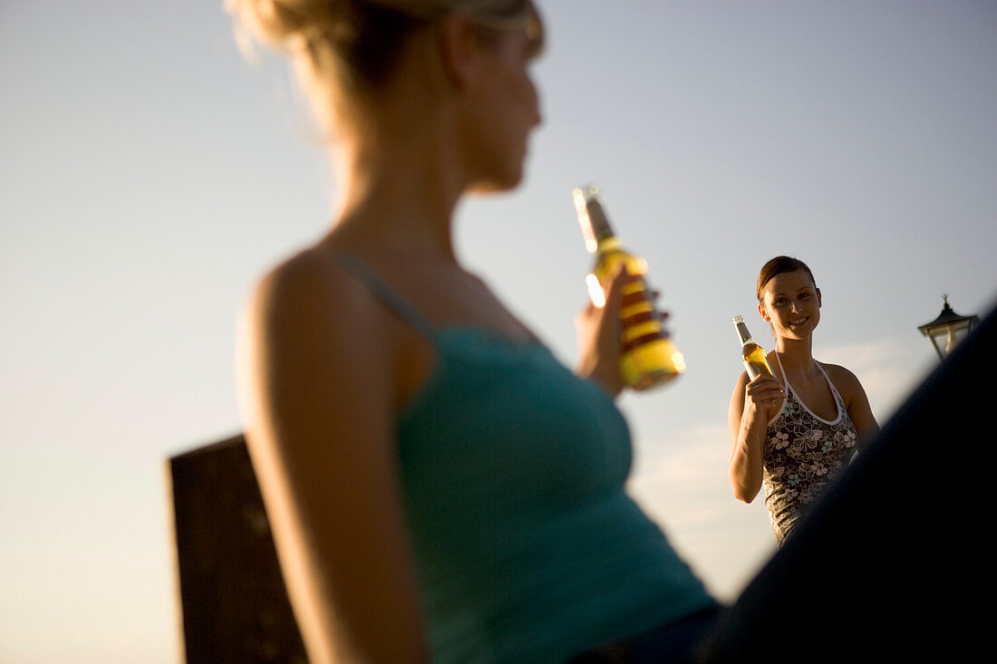 Two young women toasting each other, Munich, Bavaria