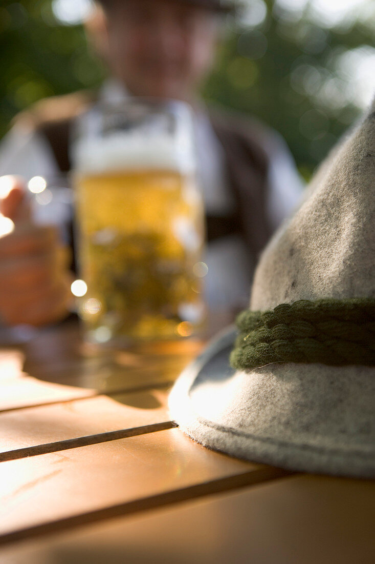 Bavarian man in beer garden, lake Starnberg, Bavaria, Germany