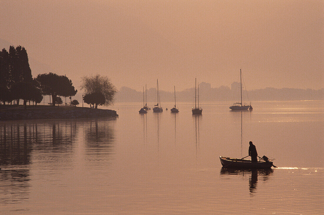 Fisherman at dusk at Lake Maggiore, Angler, Ticino, Switzerland