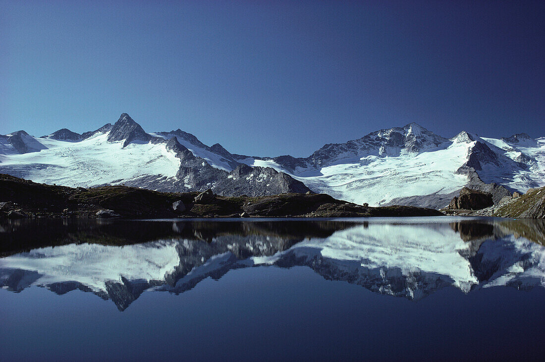 Mountain reflection in a mountain lake, Zillertal Alps, Tirol, Austria