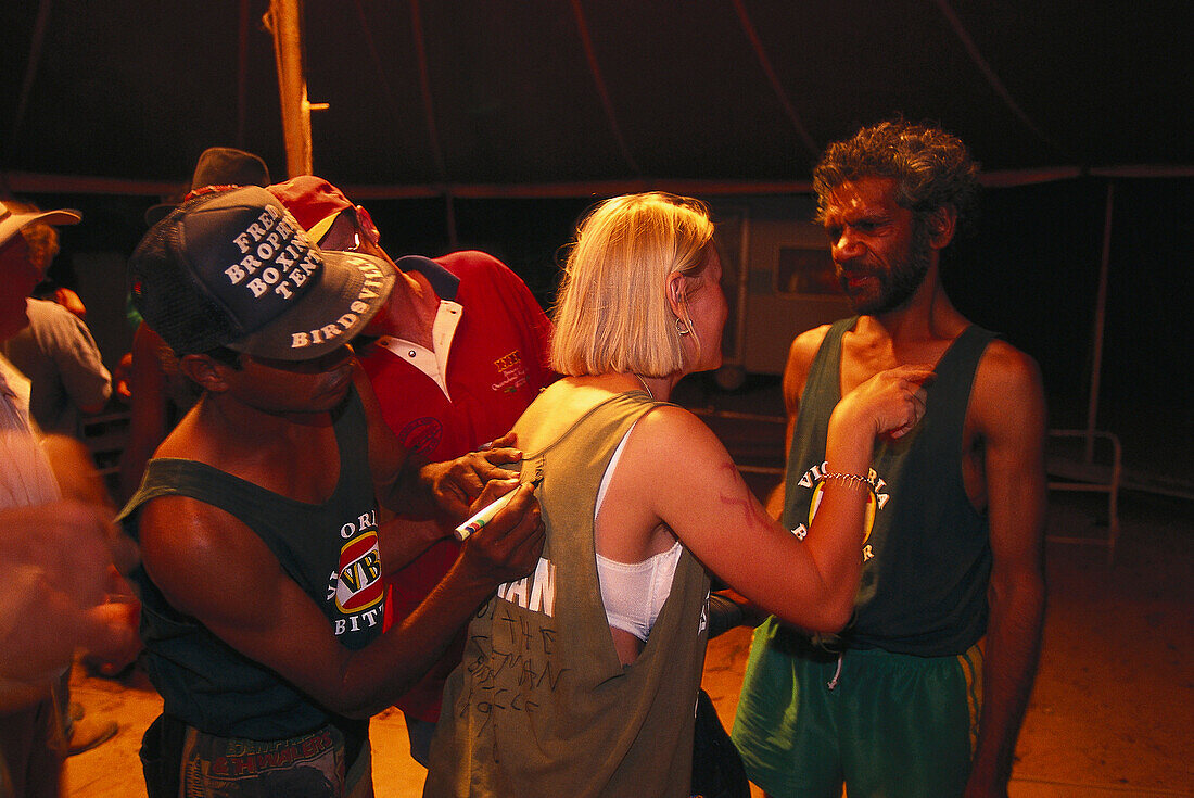 Fan, autographs after fight, Fred Brophy's Boxing Troupe, Queensland, Australia