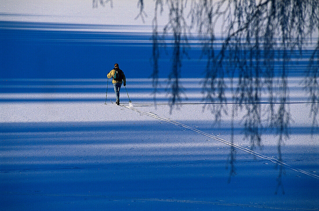 Cross country skiing, ski tracks on frozen lake, Vastergotland, Sweden