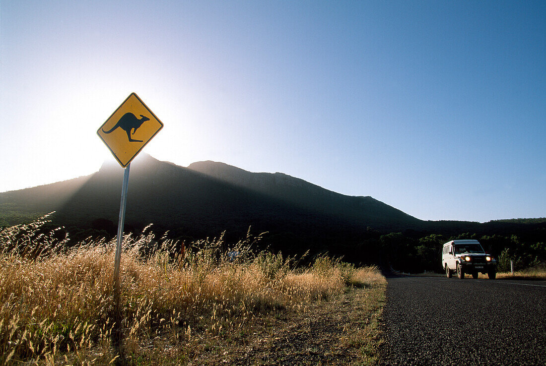 Road Sign and lonesome jeep under a blue sky at Grampians National Park, Australia