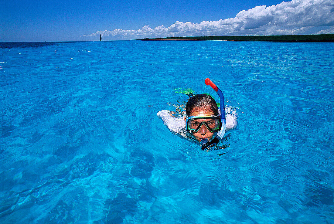 A woman snorkelling in blue water, Maternwe, Zanzibar, Tanzania, Africa