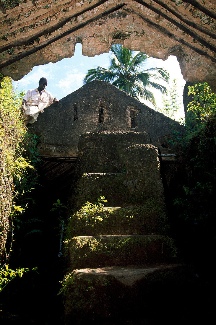 Mann an der Ruine eines ehemaligen Sklavenhauses, Sansibar, Tansania, Afrika