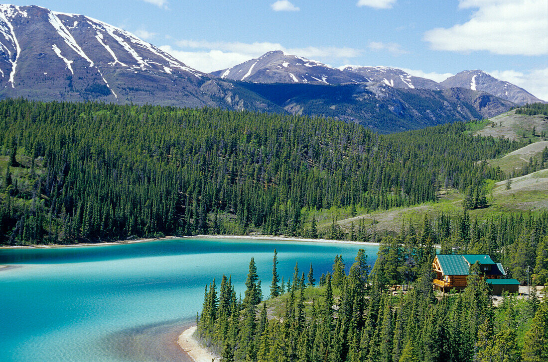 Cabin at Emerald Lake in front of snow covered mountains, Carcross, Yukon Territory, Canada, America