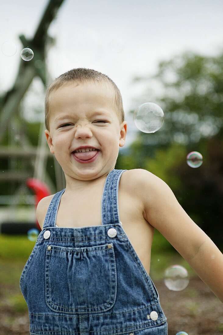 Boy with soap bubbles, people