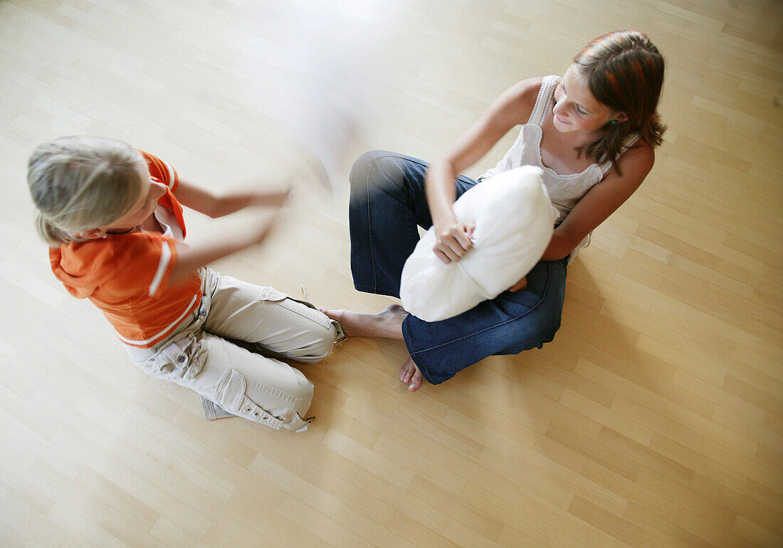 Two girls having a pillow-fight, Wellness People
