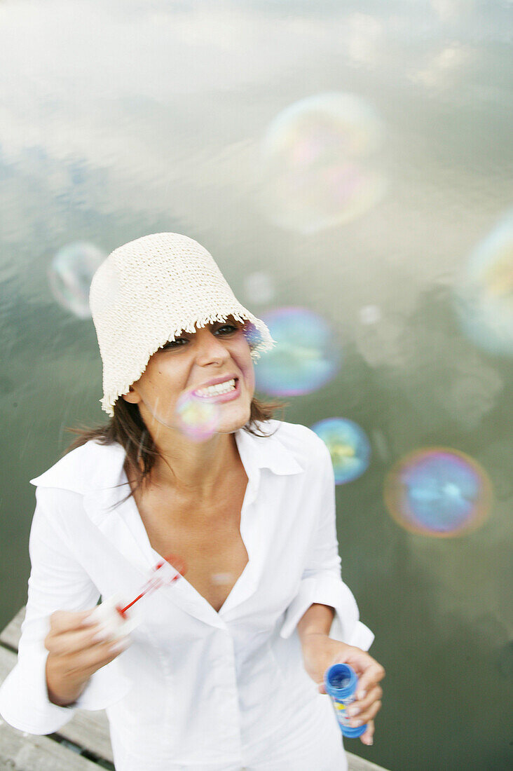 Girl making soap-bubbles, wellness people