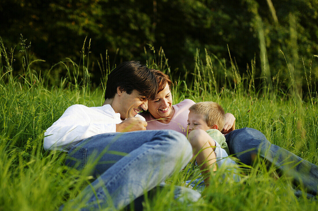 Family in nature, Family in nature, Family sitting in green meadow, Family Nature People Lifestyle