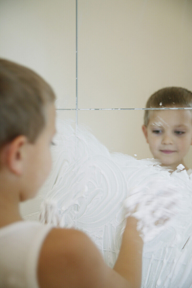 Boy playing with cream on a mirror, People Wellness Education