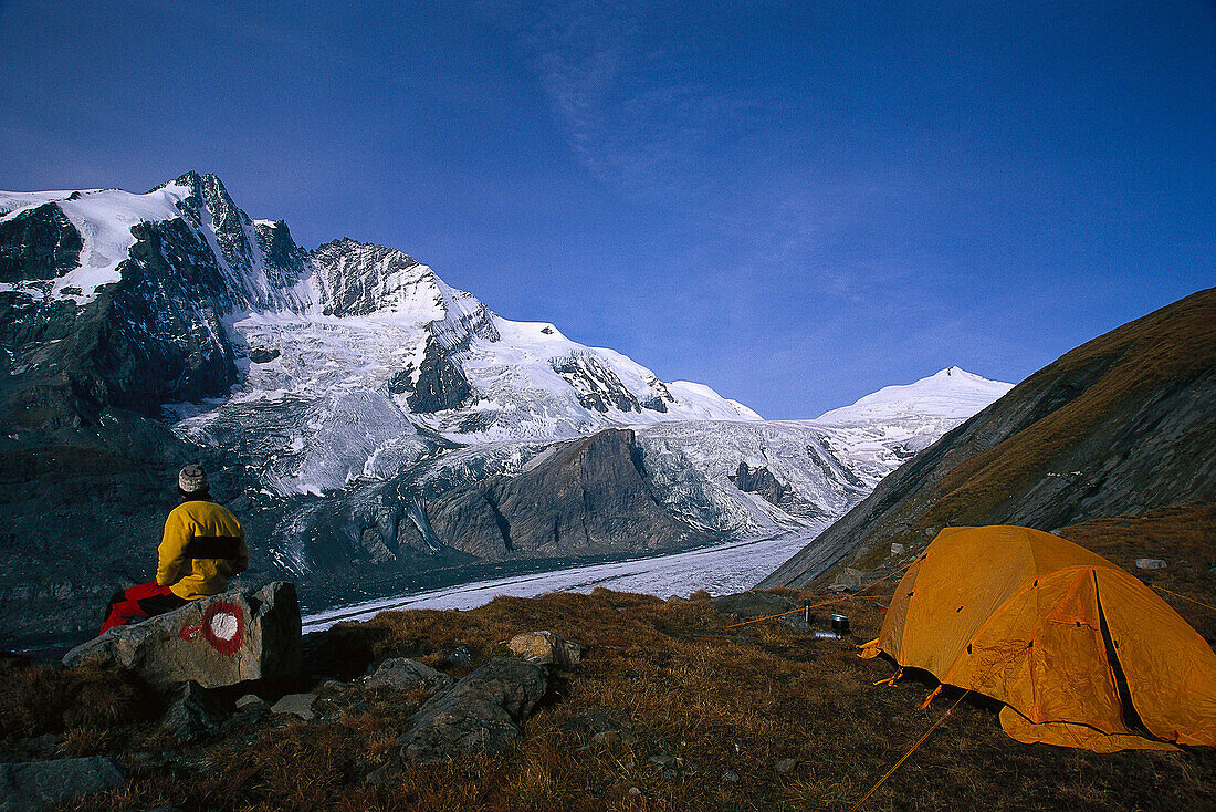 Mountaineer camping near Pasterze Glacier, Grossglockner in background, Hohe Tauern mountain range, Salzburger Land, Austria