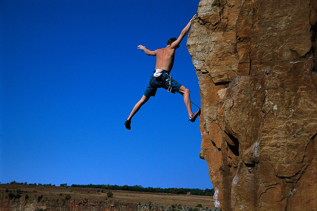 Climber stretches out arms and legs, Waterval Boven, South Africa