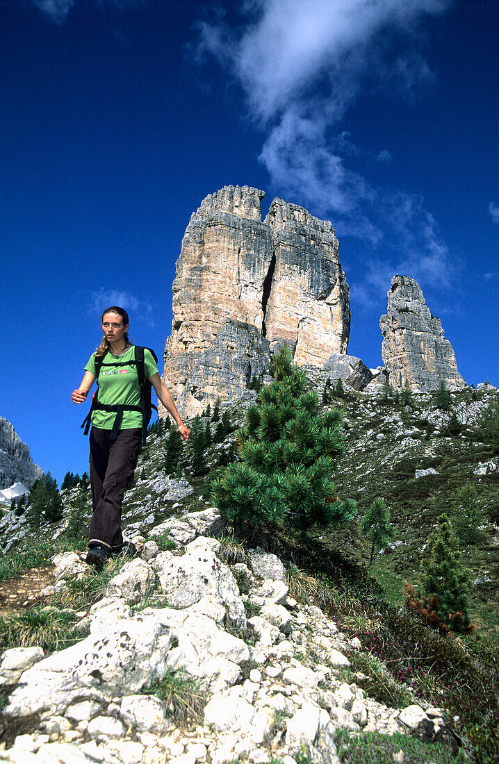 Woman hiking in the mountains, Cinque Torre, Cortina d'Ampezzo, Dolomites, South Tyrol, Italy