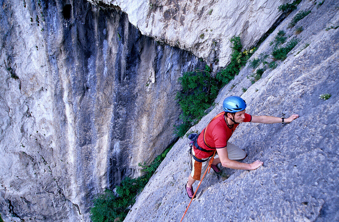 Man climbing up Il Ladro di Bagdad, Alpine climbing, Monte Cimo, Trentino, Italy