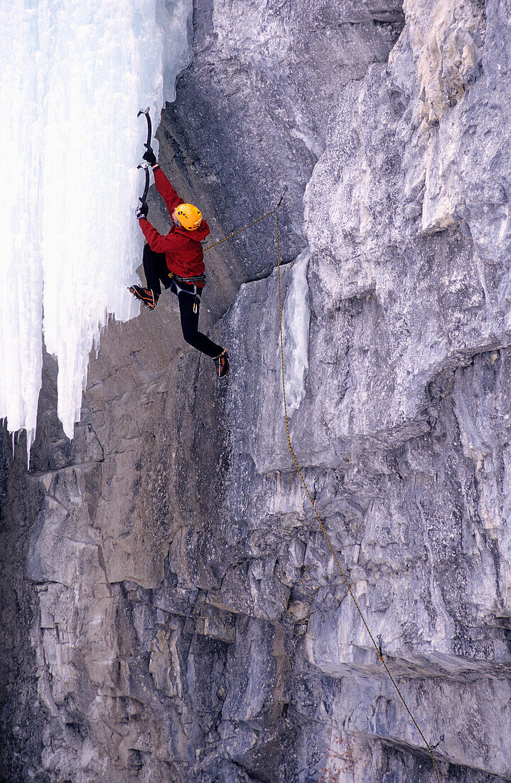 Man climbing up an ice covered rock face, Mixed Climbing, Hafner Creek Area, Banff National Park, Canada