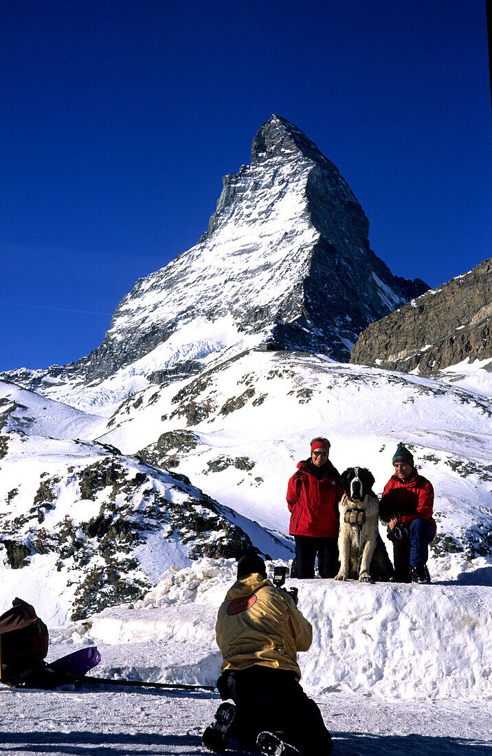 Tourists posing for camera in front of Matterhorn, Matterhorn 4478m, , Zermatt, Switzerland