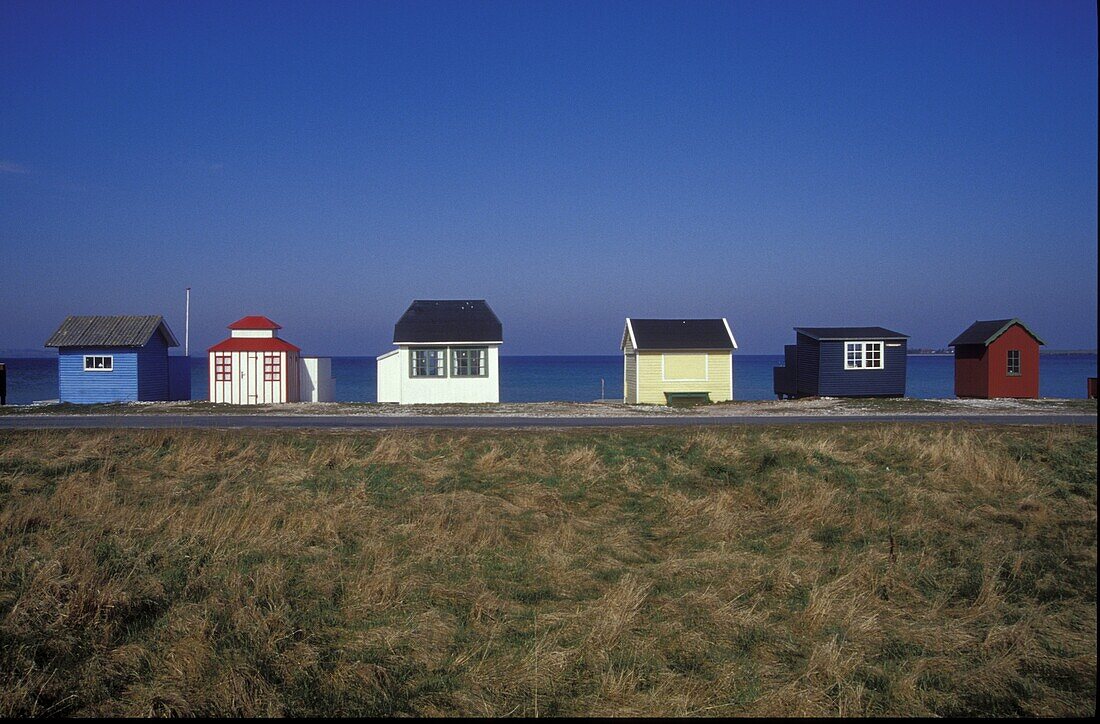 Beach cottages under blue sky, Aroskobing, Aroe, Denmark, Europe