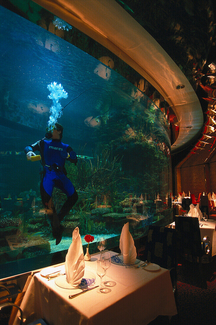 Diver in the aquarium, Al Mahara Fish Restaurant, Burj Al Arab Hotel, Dubai, United Arab Emirates