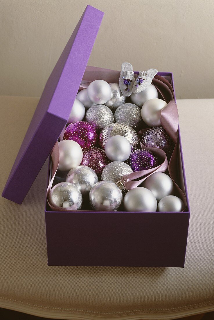 A box of silver Christmas baubles