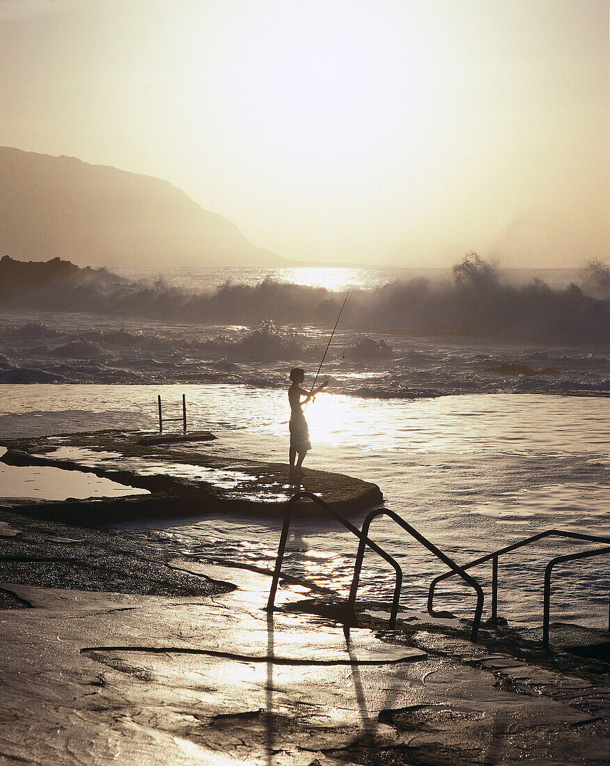 Boy angling on sea water pool, El Hierro Canary Islands, Spain
