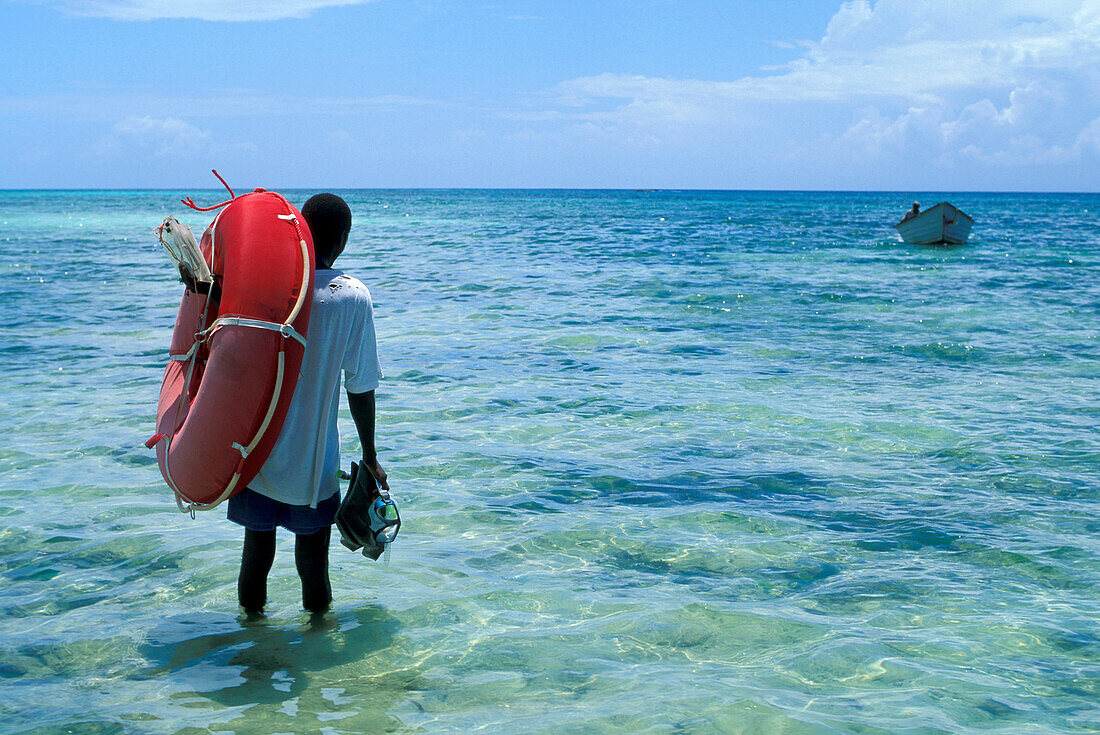 Man with snorkels and boat, Nature Reserve, Chumbe Island, Zanzibar, Tanzania