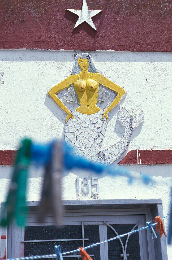 Figure of a mermaid above a door, Ilha da Culatra, Parque Natural da Ria Formosa, Algarve, Portugal, Europe