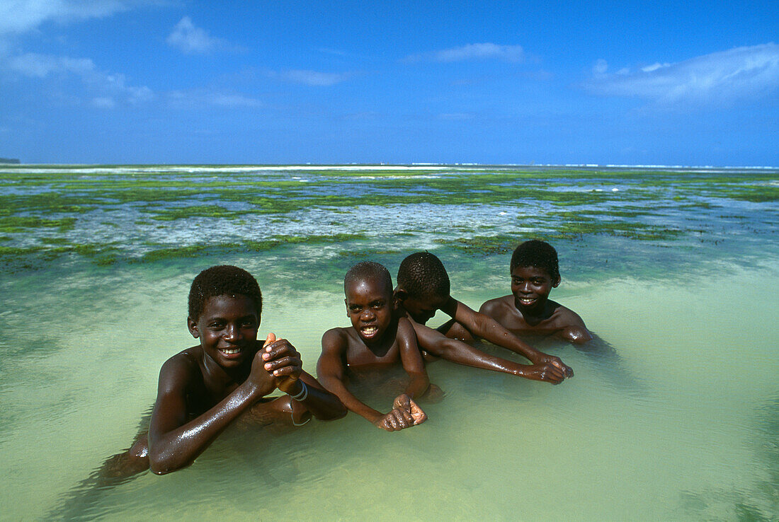 Local boys on the beach, near Paje, East coast of Zanzibar, Tanzania, Africa