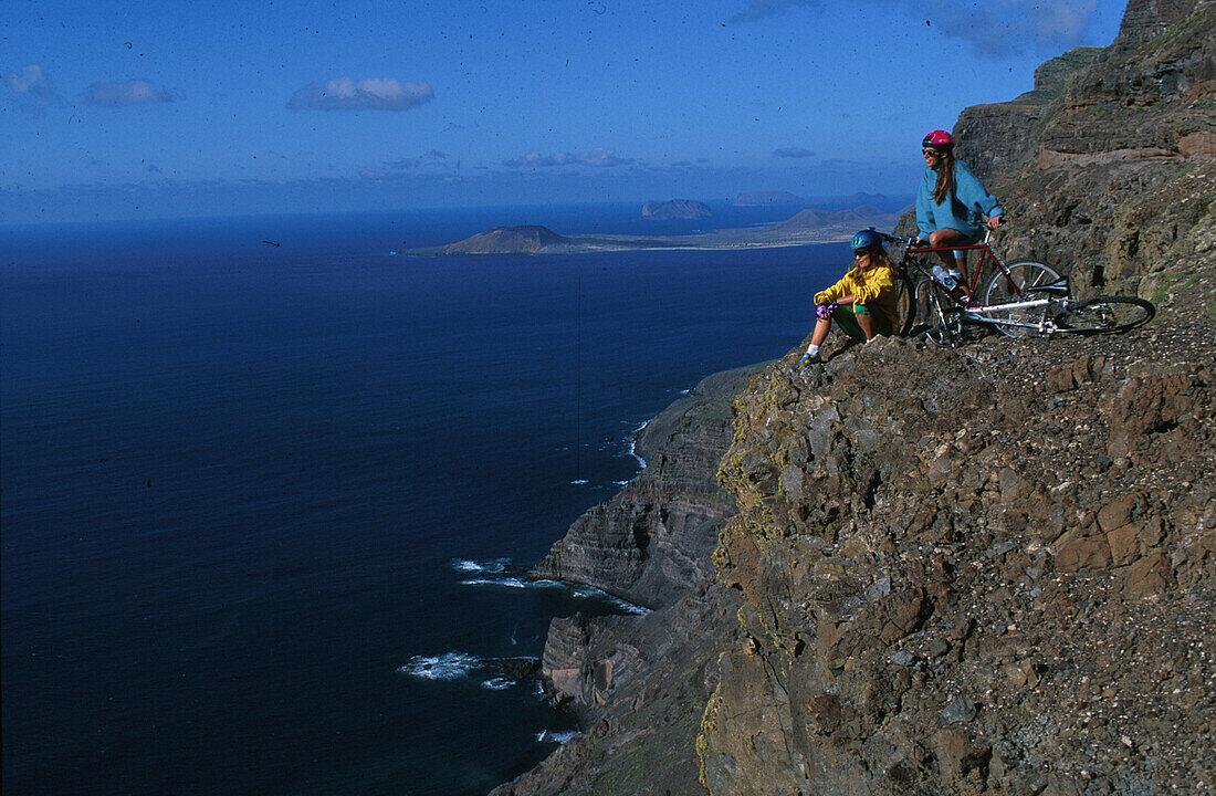 Two people having a rest during a mountain bike tour, MTB Tour, Lanzarote, Canary Islands, Spain, Fully Released