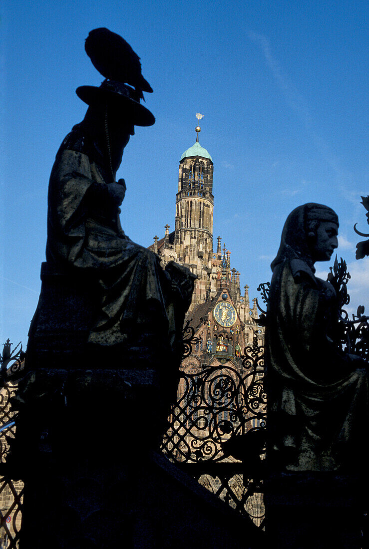 Close up of Schoener Brunnen with Our Ladys Church in the background, Nuremberg, Bavaria, Germany