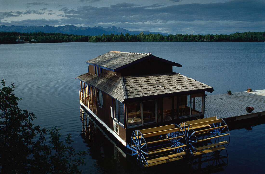 Houseboat at a wooden jetty on the Wasilla Lake in Alaska, USA