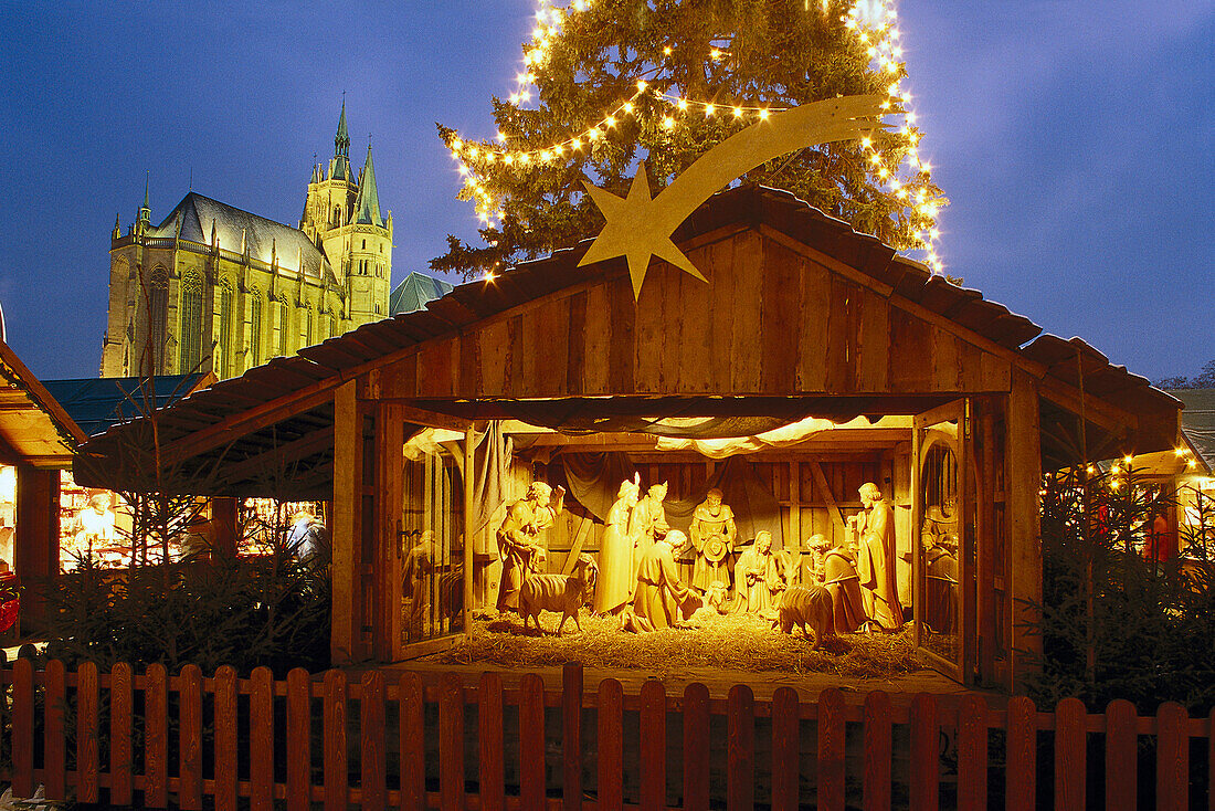 Nativity set on christmas market, cathedral in background, Erfurt, Thuringia, Germany