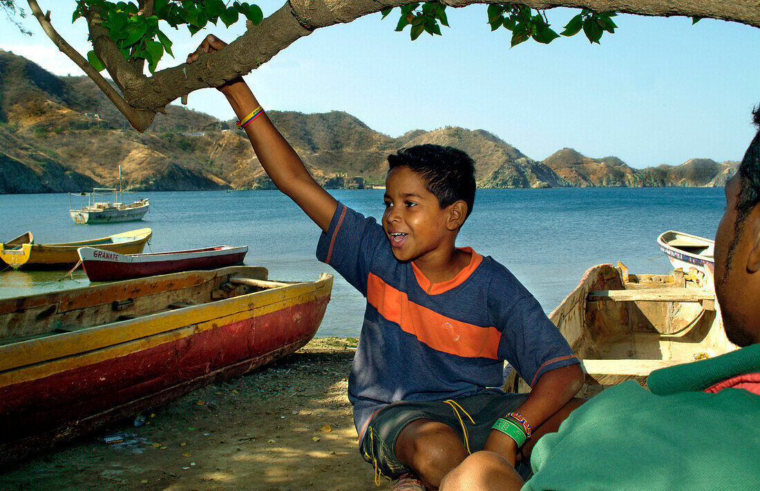 Boys sitting in Boat, Taganga, Santa Marta, Colombia, South America