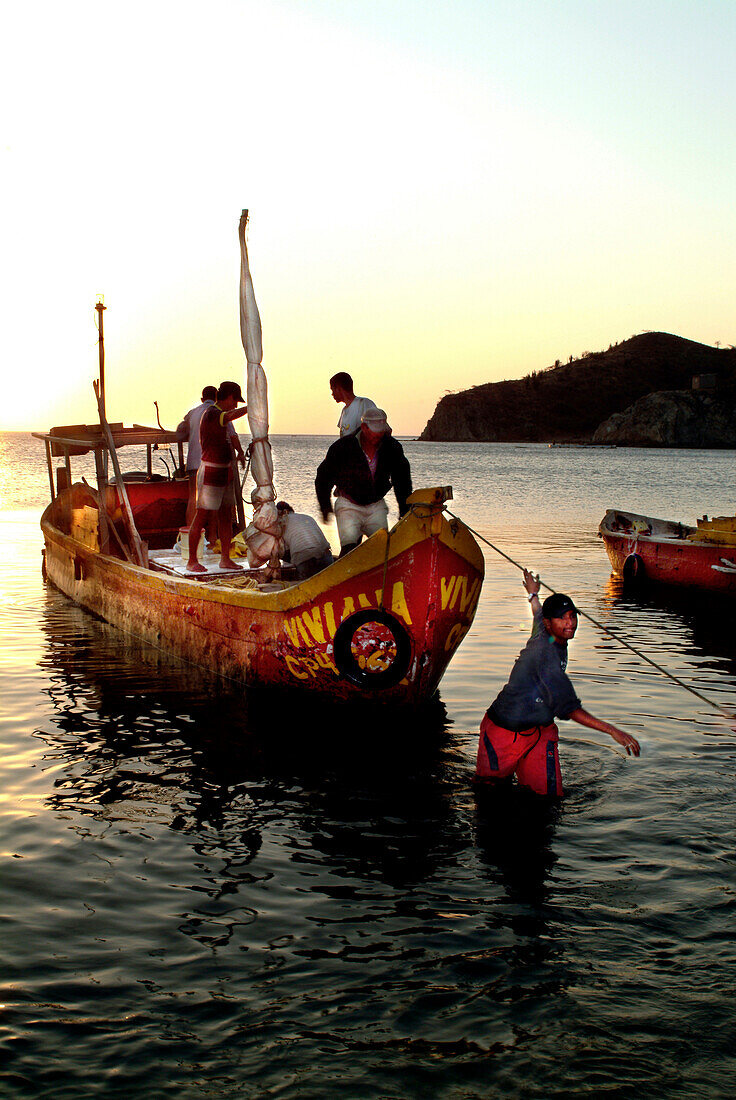 Fishermen in a boat coming back from fishing, Taganga, Santa Marta, Colombia, South America