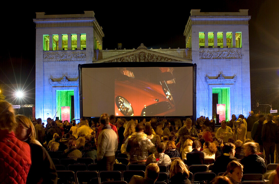 Zuschauer vor der Leinwand eines Open Air Kinos bei Nacht, Königsplatz, München, Bayern, Deutschland, Europa