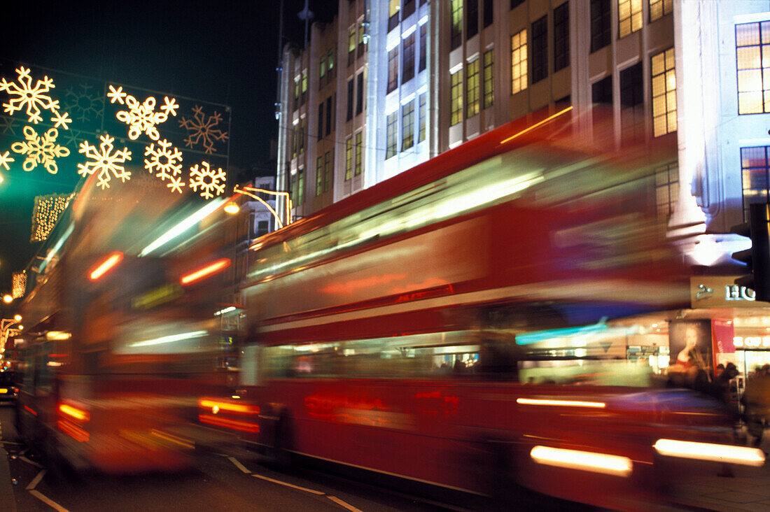 Christmas lights and double decker busses in the evening, Oxford Street, London, England, Great Britain, Europe