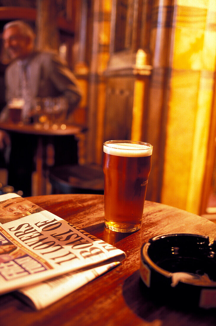 Newspaper and beer glass on a table at Black Friars Pub, London, England, Great Britain, Europe