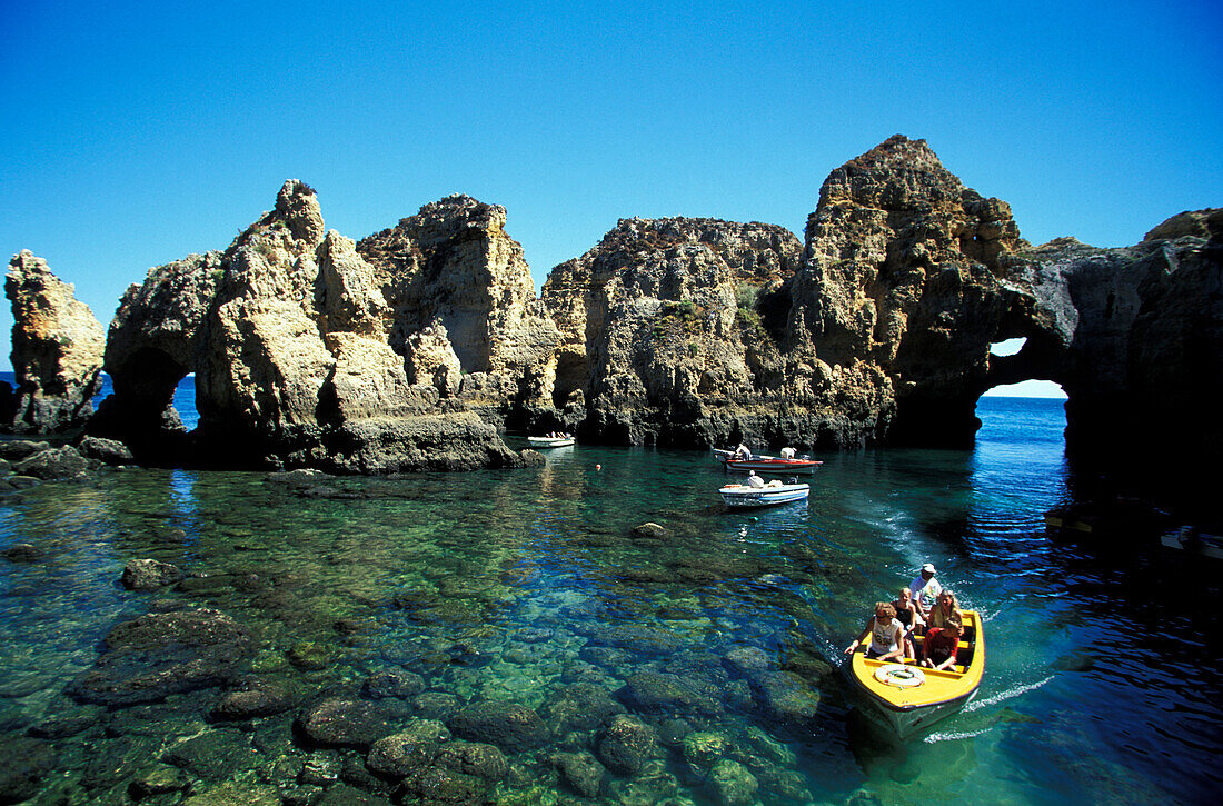 Boats in front of rock formation, Ponta da Piedade, Lagos, Algarve, Portugal, Europe