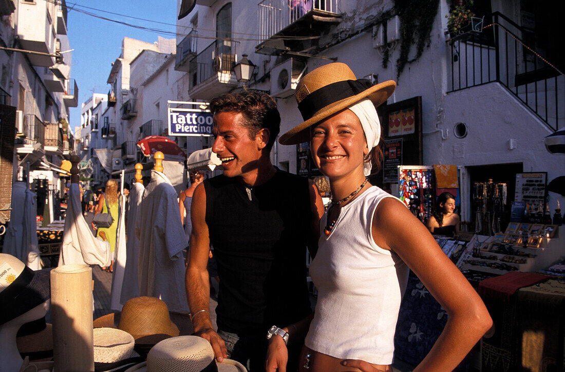Young couple shopping for hats in Ibiza Town, Ibiza, Spain