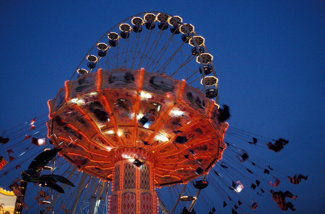 Illuminated fairground ride in the evening, Bad Cannstatt fair, Stuttgart, Baden Wuerttemberg, Germany, Europe