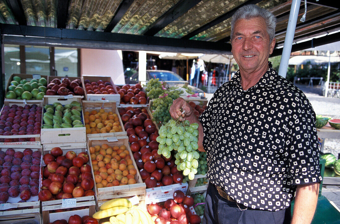 Person at a fruit stand at the market, Limone sul Garda, Lago di Garda, Italy, Europe