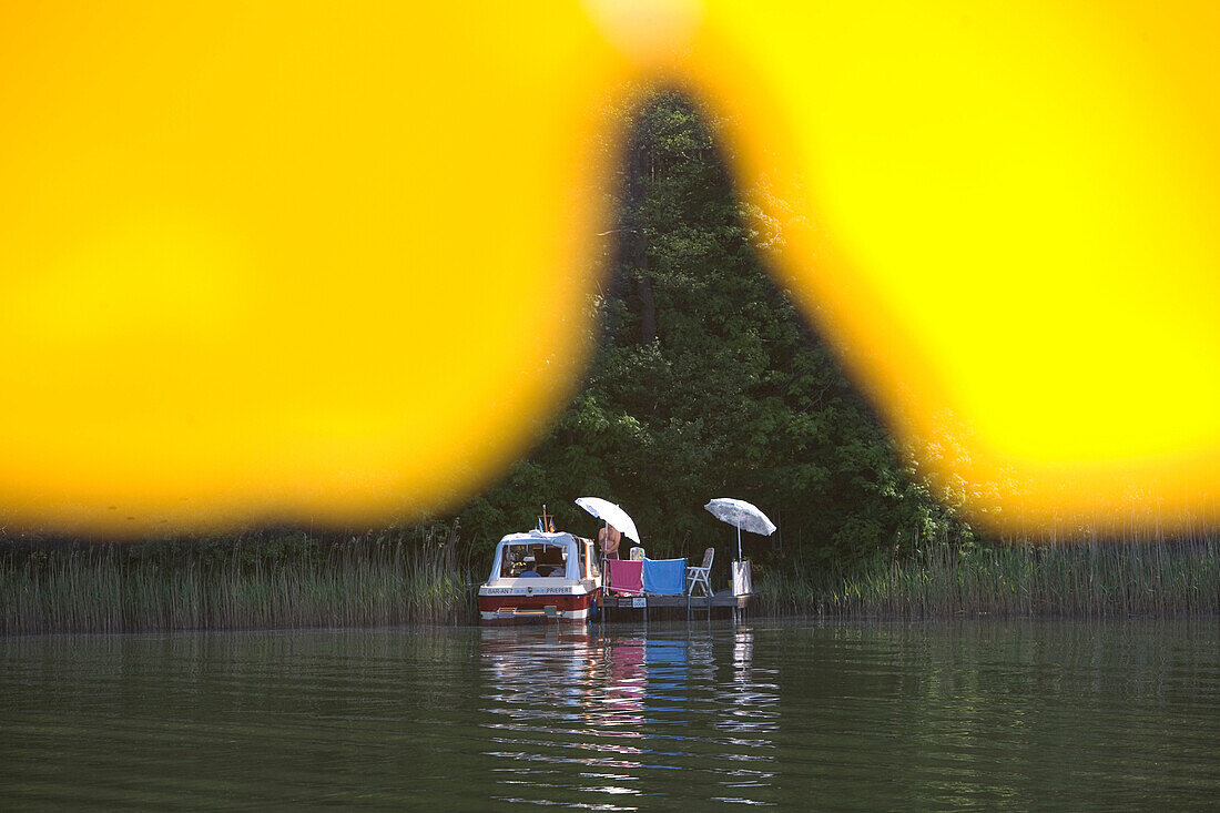 Lakeside Relaxation, View through Yellow Sun Umbrella, Lake Ellbogensee, Mecklenburgian Lake District, Germany