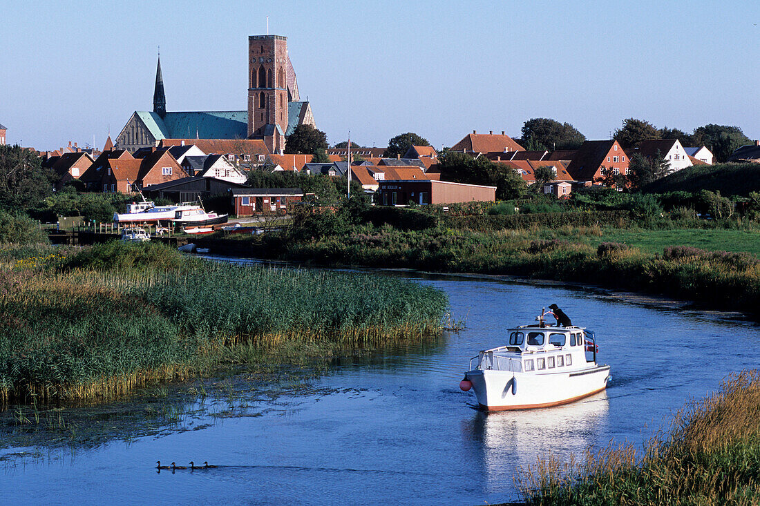 Boat on the Ribe River, Ribe cathedral in the background, Ribe, Southern Jutland, Denmark