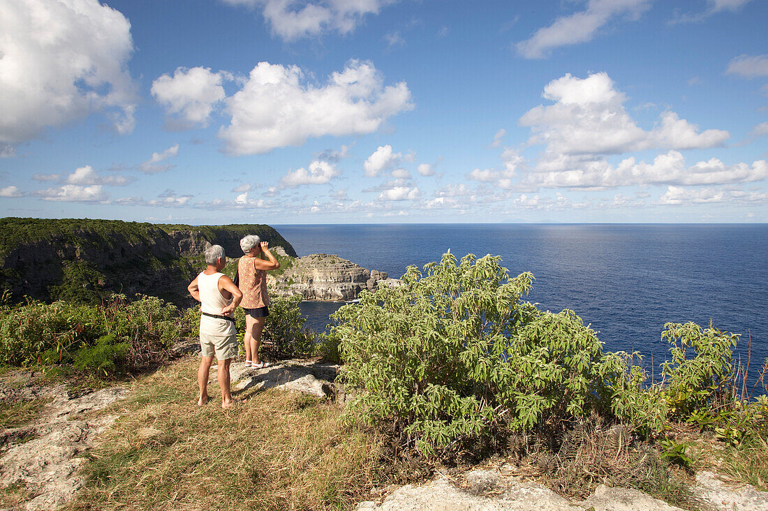 Couple, Watching, Overlooking, Binoculars, Couple at the top of a cliff, overlooking the sea panorama at Pointe de la Grande Vigie, Grande-Terre, Guadeloupe, Caribbean Sea, America
